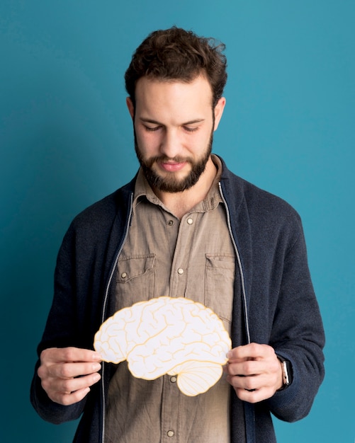 Free Photo portrait of man holding paper brain