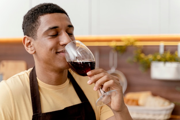 Portrait man at home drinking wine