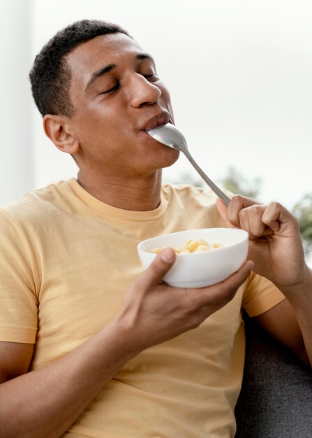 Portrait man at home eating