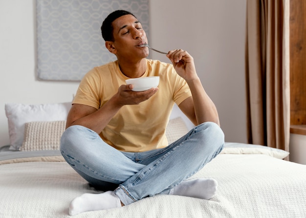 Portrait man at home eating