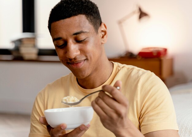 Portrait man at home eating