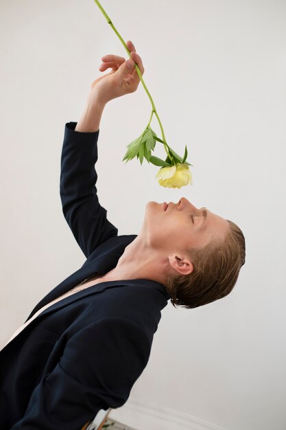 Portrait of man posing with flower