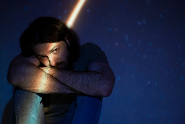 Portrait of man posing with universe projection texture