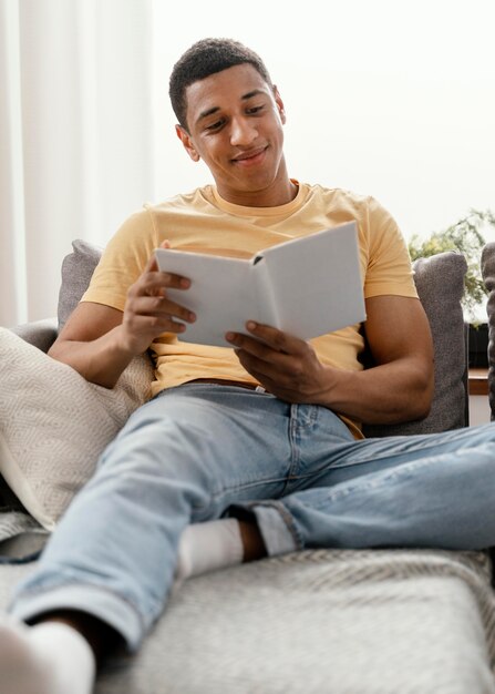 Portrait man relaxing at home reading