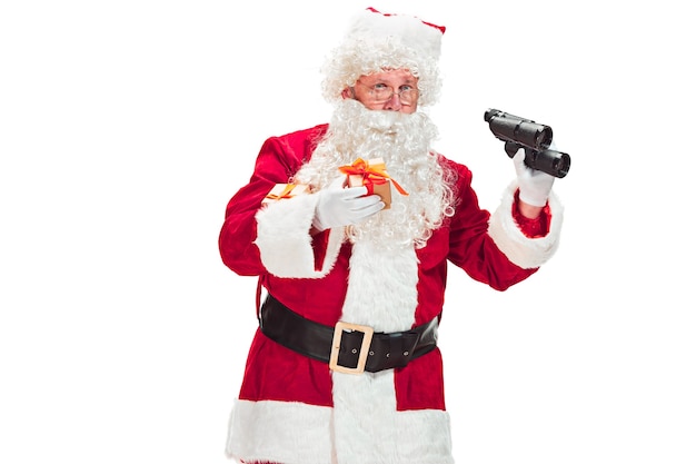 Free Photo portrait of man in santa claus costume - with a luxurious white beard, santa's hat and a red costume - in full length isolated on a white background with binoculars