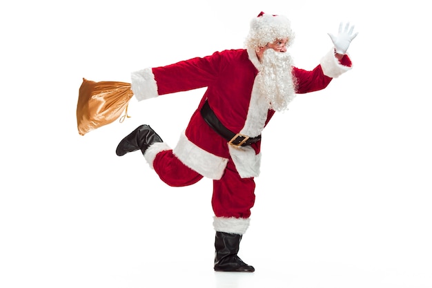 Free Photo portrait of man in santa claus costume with a luxurious white beard, santa's hat and a red costume - in full length running and isolated on white