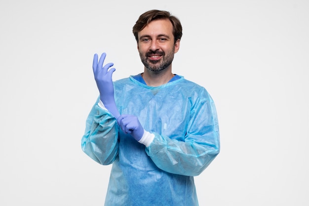 Free photo portrait of man wearing medical gown and gloves