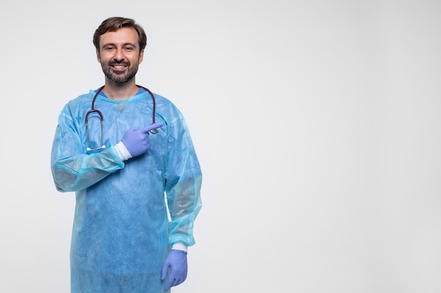 Portrait of man wearing medical gown and gloves