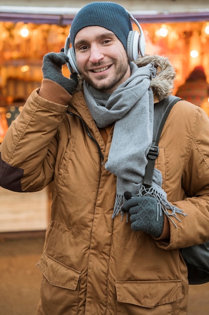 Free Photo portrait of a man wearing winter ear muffs