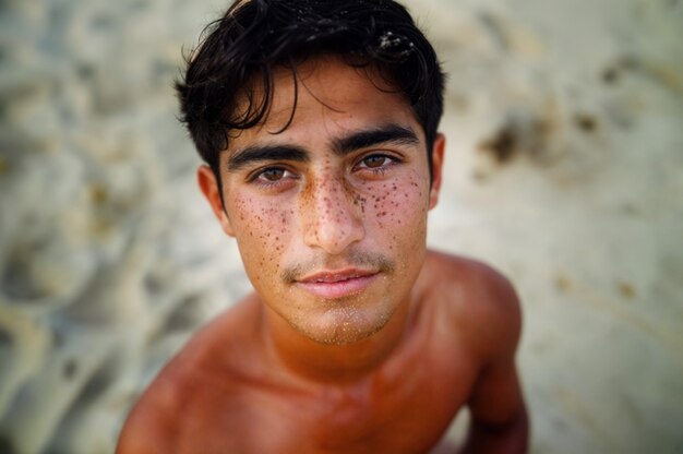 Portrait of man with freckles and beauty marks