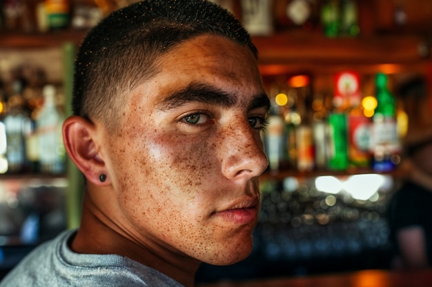 Portrait of man with freckles and beauty marks