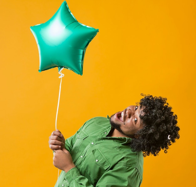 Portrait man with party balloon