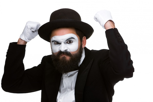 Portrait of a man with raised fists in makeup mime