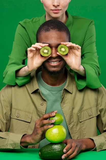 Free photo portrait of man with woman holding green fruits