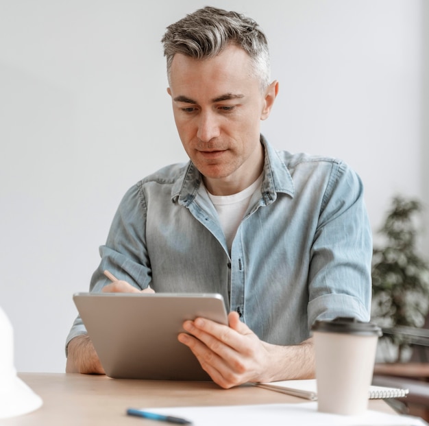 Portrait man working on tablet