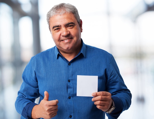 portrait of a mature man holding a paper