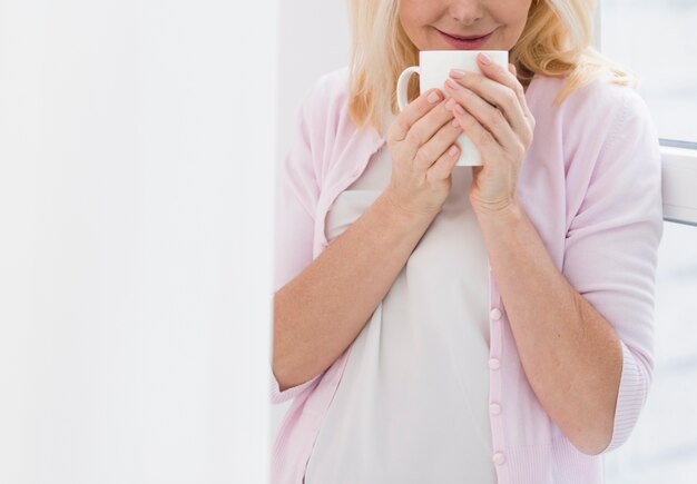 Portrait of mature woman holding a cup of coffee