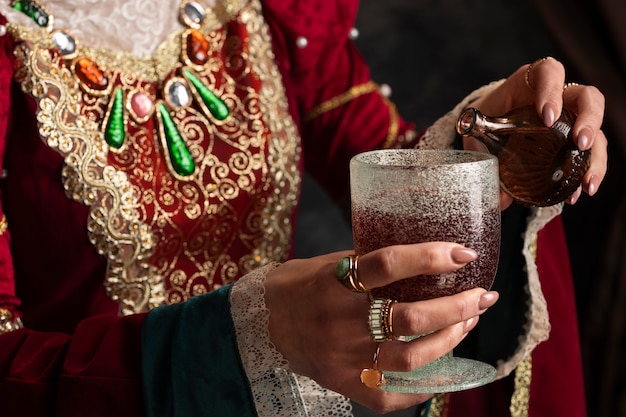 Free photo portrait of medieval queen with chalice and poison