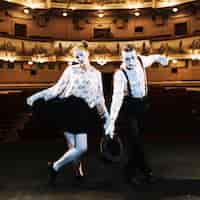 Free photo portrait of mime artist standing in the auditorium greeting