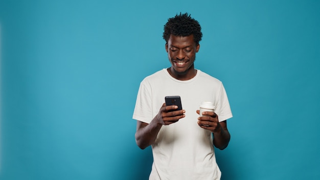 Portrait of modern person looking at display on smartphone