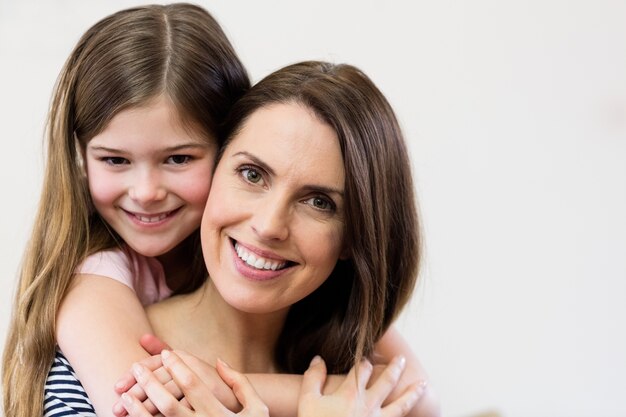 Portrait of mother and daughter embracing each other