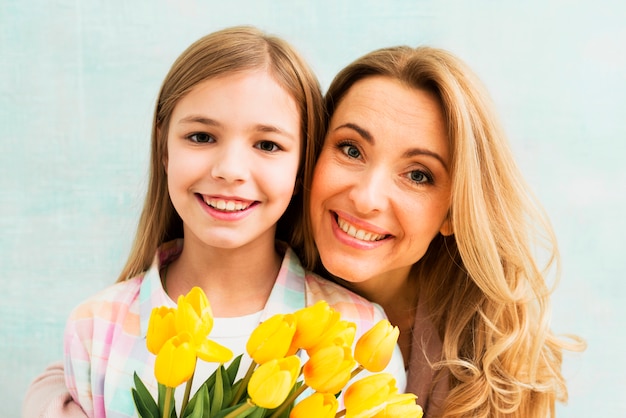 Portrait of mother and daughter smiling