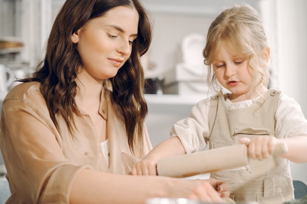 Free photo portrait of mother and little girl shaping clay together