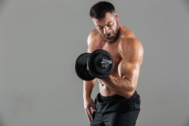 Portrait of a motivated strong shirtless male bodybuilder