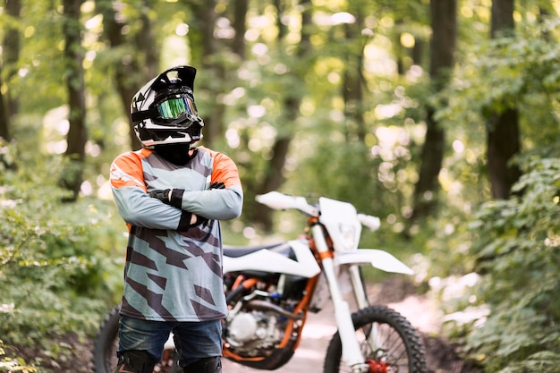 Portrait of motorbike rider posing in the forrest