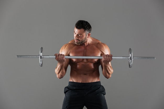 Portrait of a muscular motivated shirtless male bodybuilder