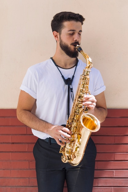 Free Photo portrait of musician playing the saxophone