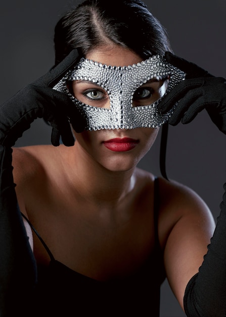 Portrait of mysterious woman with carnival mask