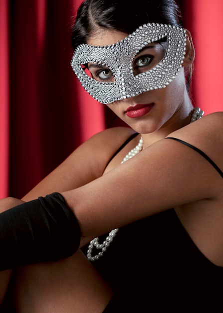 Portrait of mysterious woman with carnival mask