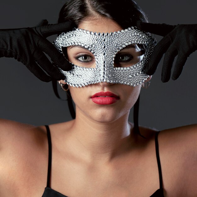 Portrait of mysterious woman with carnival mask