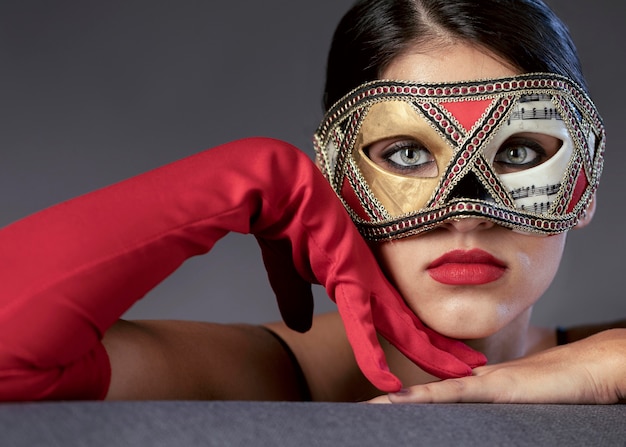 Portrait of mysterious woman with carnival mask