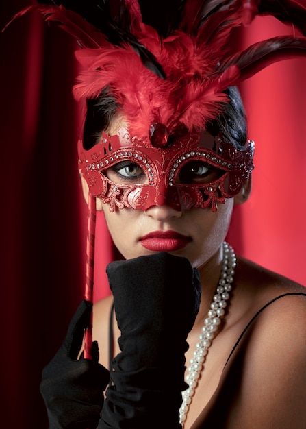 Portrait of mysterious woman with carnival mask