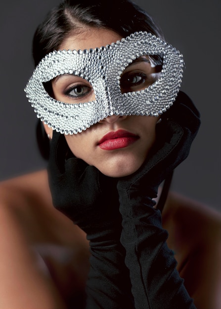 Portrait of mysterious woman with carnival mask