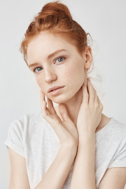 Portrait of natural redhead woman on white