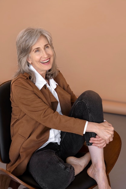 Portrait of older elegant woman sitting in a chair