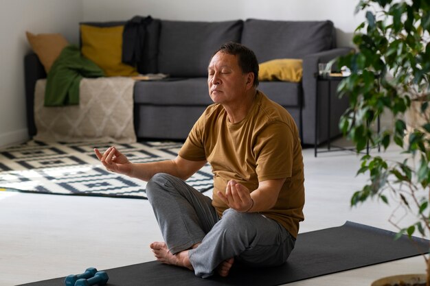 Portrait of older man meditating home