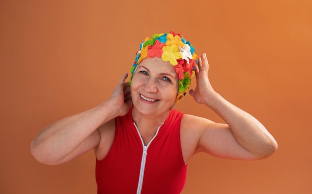 Free photo portrait of older woman with floral swim cap