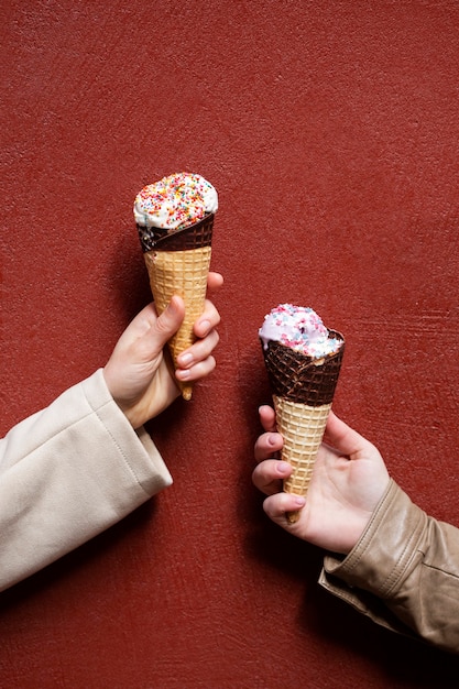 Portrait of people outdoors holding ice cream cones