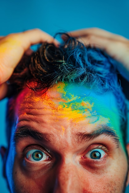 Free Photo portrait of people with colorful rainbow from their thoughts and brain on blue background