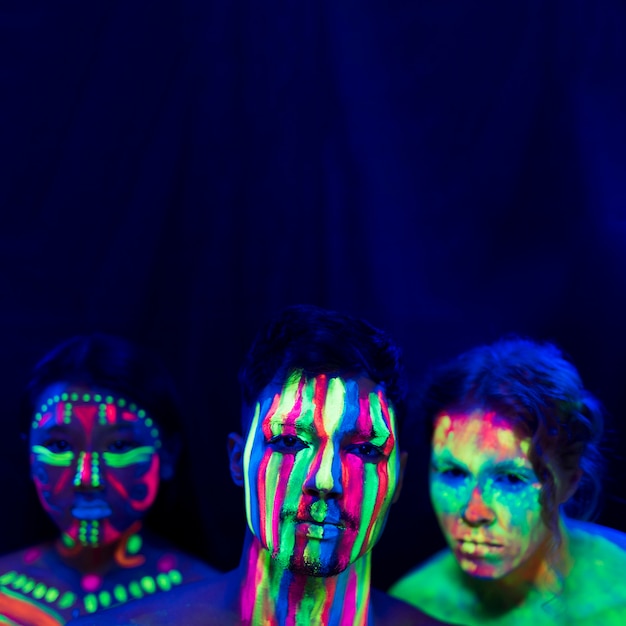 Free photo portrait of people with uv paint make-up and copy space