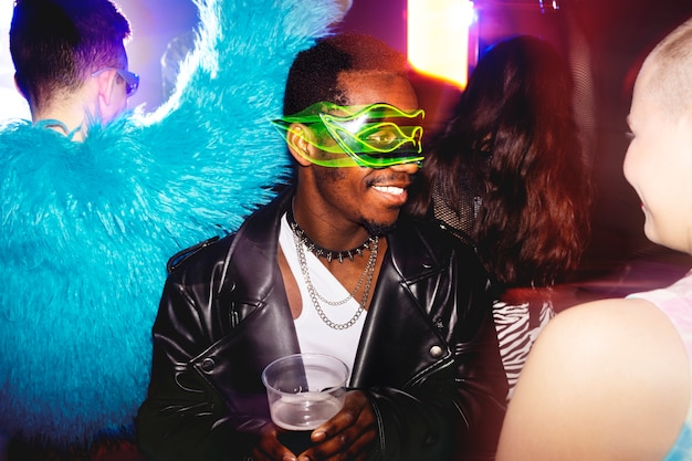 Free photo portrait of person attending a vibrant techno music party