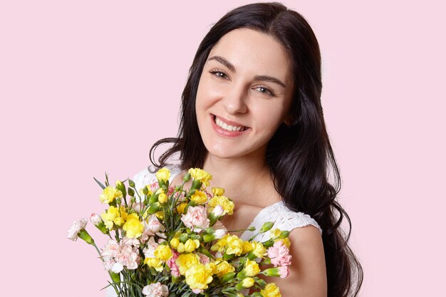 Portrait of pleasant looking woman with dark hair