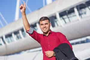 Free photo portrait of positive businessman hailing cab