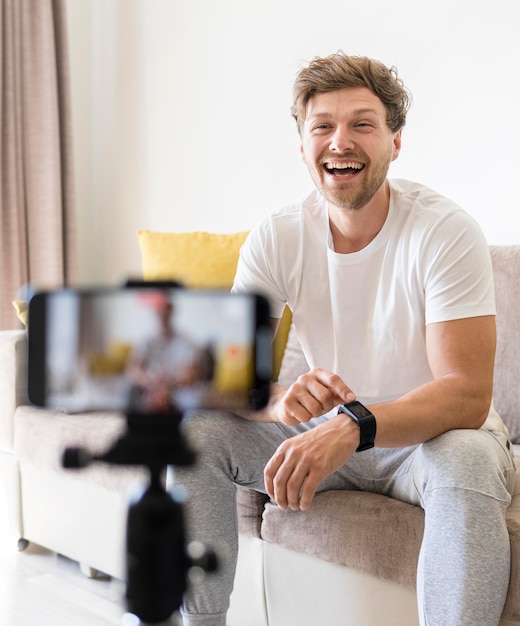 Portrait of positive man recording for personal blog