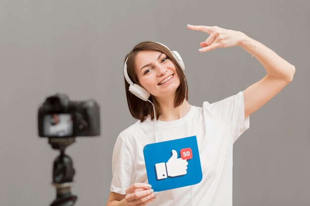 Portrait of positive woman recording video