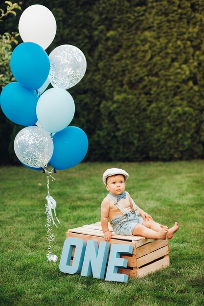 Portrait of pretty little boy in stylish clothes has a birthday today